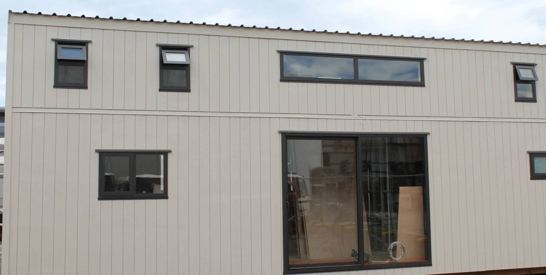 A long light-clad KDL build with multiple windows and sliding doors