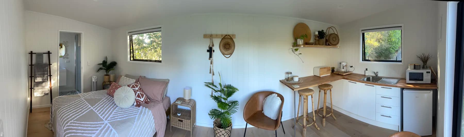 Panoramic interior view of a finished tiny home from end to end