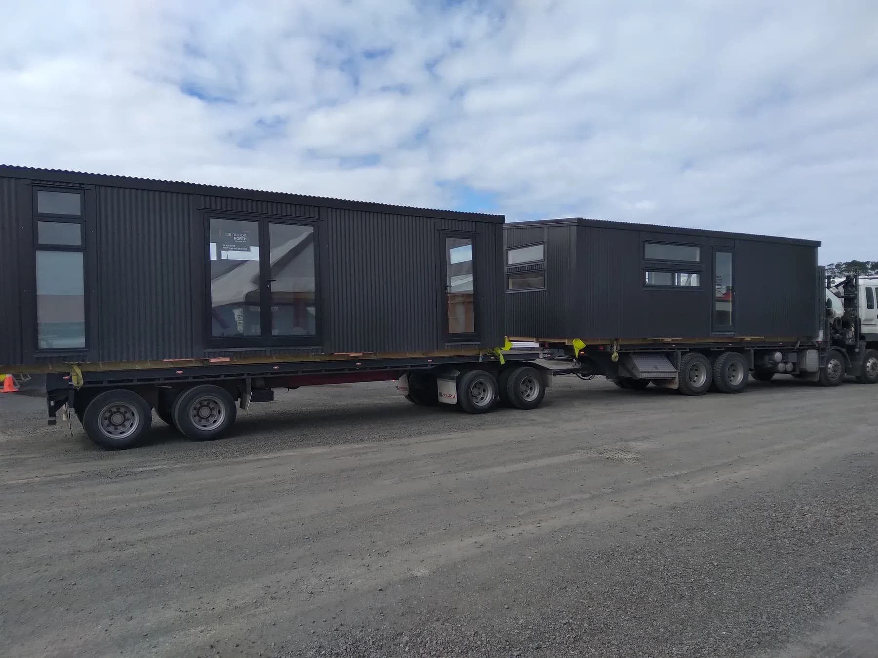 Two finished KDL homes loaded on transporters for delivery