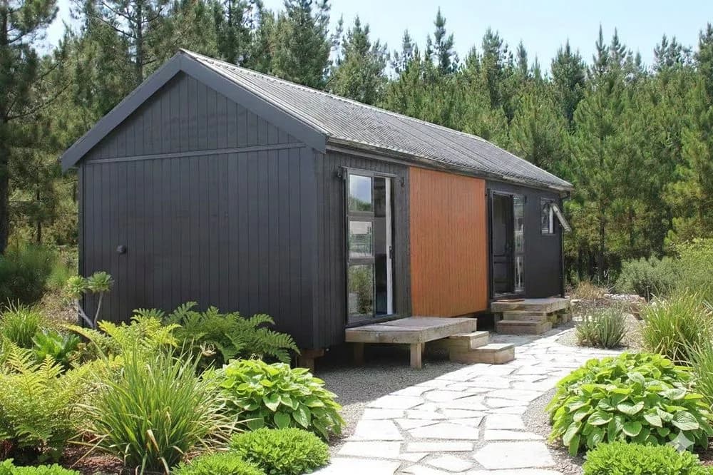 KDL code-compliant tiny home with cedar accent and stone path